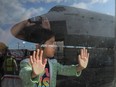 A child gazes at the Space Shuttle Endeavour on its final journey in 2012. Children can easily see through mindless jibber-jabber questions adults ask, Hayley Juhl writes.