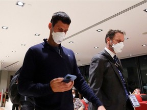 Serbian tennis player Novak Djokovic walks in Melbourne Airport before boarding a flight, after the Federal Court upheld a government decision to cancel his visa to play in the Australian Open, in Melbourne, Australia, January 16, 2022.