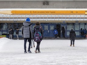 Students outside the entrance to École secondaire St-Laurent on Thursday February 3, 2022.