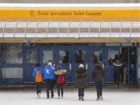 Students return to École secondaire St-Laurent after a break between classes Thursday February 3, 2022. Three basketball coaches at the school have been arrested on charges involving minors.