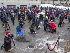 Catholics celebrate New Year's mass in the parking lot behind Mary Queen of the World Cathedral in Montreal Jan. 1, 2022.