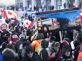 MONTREAL, QUE.: FEBRUARY 5, 2022 --  Signs carried along by protesters on Grande Allee next to Quebec's National Assembly during massive protest against COVID-19 vaccine and health restrictions on Saturday February 5, 2022. (Pierre Obendrauf / MONTREAL GAZETTE) ORG XMIT: 67360 - 1257