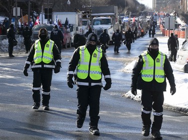 Quebec police officers on Grande Allée next to Quebec's National Assembly during a massive protest against COVID-19 vaccine and health restrictions on Saturday, Feb. 5, 2022.