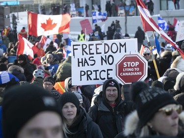 Signs carried along by protesters on Grande Allée next to Quebec's National Assembly during massive protest against COVID-19 vaccine and health restrictions on Saturday, Feb. 5, 2022. 1257