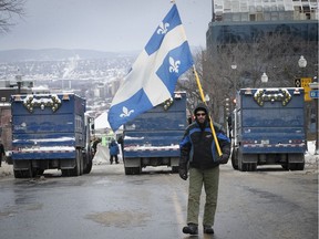A lone demonstrator makes his way to the National Assembly in Quebec City on Feb. 6, 2022 as part of protests against COVID-19 restrictions. Allison Hanes writes that Premier François Legault will surely attempt to turn the assertion of federal authority back against Ottawa — especially if there is an escalation of protests in Quebec.