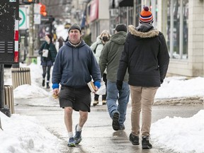 A pedestrian found temperatures moderate enough for shorts while walking on Sherbrooke St in Montreal Feb. 7, 2022.