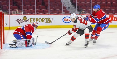 New Jersey Devils' Jesper Bratt gets behind Montreal Canadiens' defenceman Ben Chiarot for a scoring opportunity on goalie Cayden Primeau who made the save during second period in Montreal Tuesday, Feb. 8, 2022.