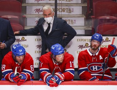Montreal Canadiens head coach Dominique Ducharme watches the last minute of loss to the New Jersey Devils during third period in Montreal Tuesday, Feb. 8, 2022.   On the bench are Mike Hoffman, left, Josh Anderson and Paul Byron.