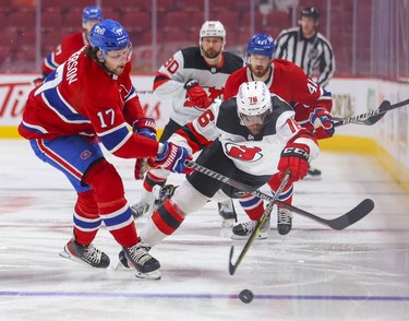 Montreal Canadiens' Josh Anderson, left, and New Jersey Devils' P.K. Subban compete for loose puck during first period in Montreal, Tuesday, Feb. 8, 2022. Canadiens Paul Byron and Devils Tomas Tatar follow play.