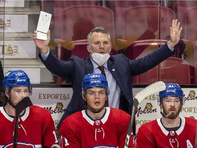 Canadiens interim head coach Martin St. Louis questions a referee's call during the third period Thursday night at the Bell Centre. Players on bench are Josh Anderson, from left, Jake Evans and Paul Byron.
