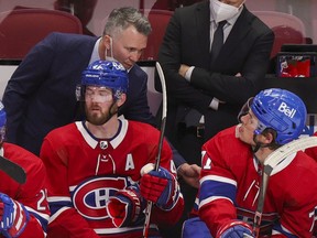 Canadiens interim head coach Martin St. Louis speaks to Jake Evans during the second period Thursday night at the Bell Centre.