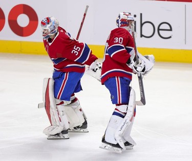 Montreal Canadiens' Sam Montembeault, left, skates past team-mate Cayden Primeau after Primeau was pulled from the game against the Washington Capitals during second period in Montreal Thursday, Feb. 10, 2022 after giving up 4 goals in less then two periods.