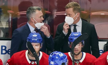 Montreal Canadiens interim head coach Martin St. Louis, left, consults with assistant coach Trevor Letowski during second period in Montreal Thursday, Feb. 10, 2022.