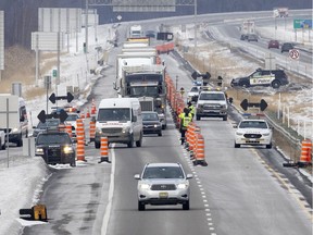 Sûreté du Québec officers stop vehicles heading to the U.S. border crossing at Lacolle on Wednesday, February 16, 2022. Police spoke with every driver before allowing them to continue to the border crossing.