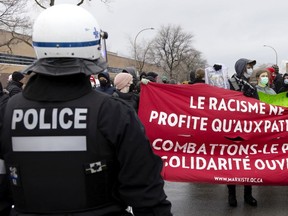 Montreal police officers were seen sporting "thin blue line" symbols during protests against COVID public health measures.