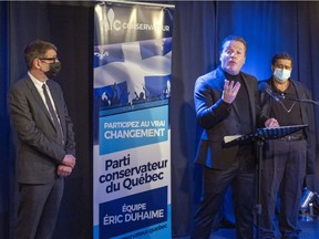 Dr. Karim Elayoubi answers questions in Notre-Dame-de-Grâce on Thursday February 17, 2022 after being introduced as a Conservative Party of Quebec candidate for the upcoming election by party leader Éric Duhaime, left. Fellow Conservative candidate Dr. Roy Eappen looks on.