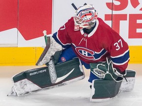 Canadiens goaltender Andrew Hammond  stretches during warmup prior to the game against the St. Louis Blues in Montreal on Thursday, Feb. 17, 2022.