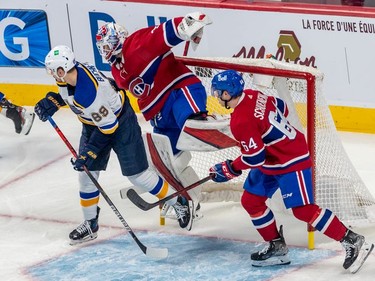 Montreal Canadiens goaltender Sam Montembeault (35) is checked into the net by St. Louis Blues left wing Pavel Buchnevich (89), knocking the net off its moorings during first period against the St. Louis Blues in Montreal on Thursday, Feb. 17, 2022.