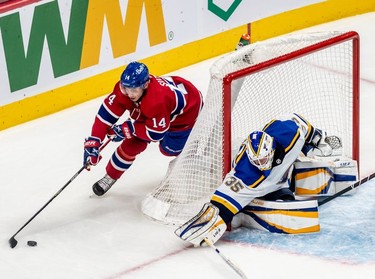 Montreal Canadiens centre Nick Suzuki (14) tries a wrap-around against St. Louis Blues goaltender Ville Husso (35) during first period against the St. Louis Blues in Montreal on Thursday, Feb. 17, 2022.
