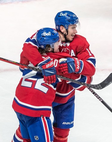 Montreal Canadiens right wing Cole Caufield (22) is congratulated by teammate Montreal Canadiens centre Nick Suzuki (14) after scoring the tying goal against the St. Louis Blues in the dying seconds of the third period in Montreal on Thursday, Feb. 17, 2022.