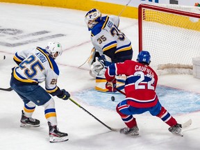 Blues centre Jordan Kyrou couldn't prevent Canadiens' Cole Caufield from scoring the winning overtime goal against Blues goaltender Ville Husso Thursday night at the Bell Centre.