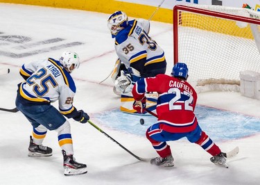 St. Louis Blues centre Jordan Kyrou (25) couldn't prevent Montreal Canadiens right wing Cole Caufield (22) from scoring the game winning overtime goal against St. Louis Blues goaltender Ville Husso (35) in Montreal on Thursday, Feb. 17, 2022.