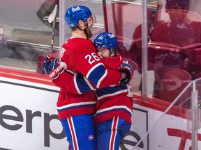 Canadiens' Cole Caufield, right, is congratulated by Jeff Petry after scoring the winning goal in overtime against the Blues Thursday night at the Bell Centre.