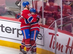 Cole Caufield (right) is congratulated by Canadiens teammate Jeff Petry after scoring overtime goal for 3-2 win over the St. Louis Blues at the Bell Centre on Feb. 17.
