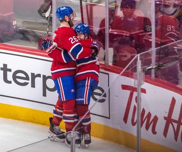 Montreal Canadiens right wing Cole Caufield (22) is congratulated by teammate Jeff Petry (26) after scoring the an overtime goal against the St. Louis Blues in Montreal on Thursday, Feb. 17, 2022.