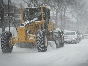 Montrealer commuters follow a snowplow during morning rush hour after the nearly 20 centimetres of snow fell Feb. 18, 2022.