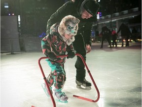 Tibeau Mathews helps his daughter Leila up her stakes and the newly opened outdoor rink.