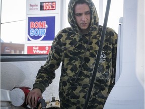 Pascal Deschatelets fills up his truck at a gas station near the Metropolitan Expressway on Wednesday Feb. 23, 2022. High gas prices are now the norm in Montreal.