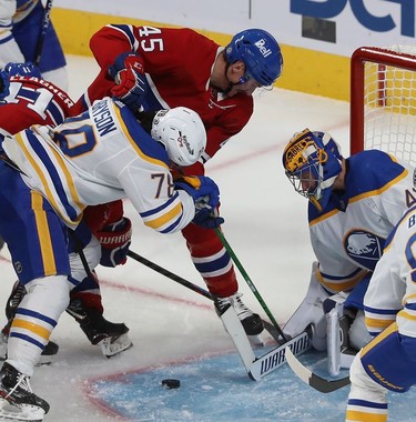 Montreal Canadiens' Laurent Dauphin (45) is tied up by Jacob Bryson (78) in front of goaltender Craig Anderson during second period NHL action in Montreal on Wednesday, Feb. 23, 2022.