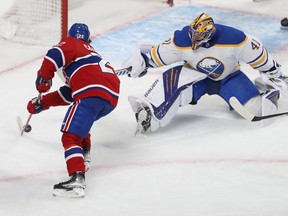 Montreal Canadiens' Cole Caufield (22) tries to put the puck past Buffalo Sabres goaltender Craig Anderson during first-period NHL action in Montreal on Wednesday February 23, 2022.