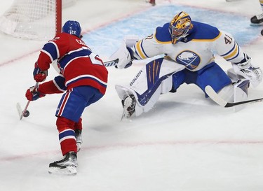 Montreal Canadiens' Cole Caufield (22) tries to put puck past Buffalo Sabres goaltender Craig Anderson during first-period NHL action in Montreal on Wednesday, Feb. 23, 2022.