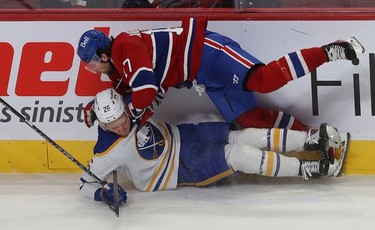 Montreal Canadiens' Josh Anderson (17) brings down Buffalo Sabres' Rasmus Dahlin during first-period NHL action in Montreal on Wednesday, Feb. 23, 2022.