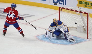 Montreal Canadiens' Nick Suzuki (14) scores on penalty shot on Buffalo Sabres goaltender Craig Anderson during second-period NHL action in Montreal on Wednesday, Feb. 23, 2022.