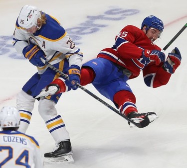 Montreal Canadiens' Laurent Dauphin (45) flies through the air after being upended by Buffalo Sabres' Rasmus Dahlin (26) during first-period NHL action in Montreal on Wednesday, Feb. 23, 2022.