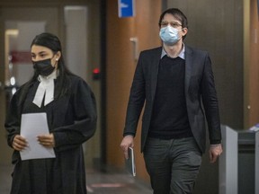 Alleged neo-Nazi Gabriel Sohier Chaput follows his lawyer to the courtroom for the first day of his trial at the Montreal courthouse, where he is charged with inciting hatred, on Feb. 28, 2022.