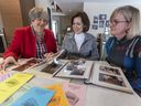 Beaconsfield Newcomers Club members Ursula Kucher-Hogg, left, Lori Vandzura and Cindy Gilmore, right, browse albums at Vandzura.  The club celebrates its 50th anniversary a year late due to the pandemic.