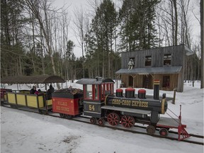 A train takes visitors around the property and in front of an old western building at Le Chalet des Érables in Ste-Anne-des-Plaines, north of Montreal.