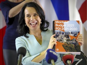 Montreal Mayor Valérie Plante holds up a copy of the city's budget in November 2020. “I fervently hope that ... the provincial and federal government will provide significant support for the public transit system,” Plante said Wednesday as she outlined Montreal's priorities for the upcoming federal budget.