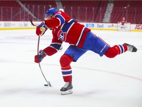 Montreal Canadiens' Nick Suzuki takes a shot on Philadelphia Flyers goalie Carter Hart in Montreal on Dec. 16, 2021.