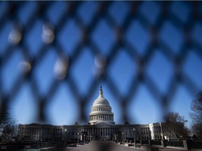 The U.S. Capitol, behind security fencing, is shown on Jan. 10, 2021. A pro-Trump mob stormed the Capitol four days earlier as Congress held a joint session to ratify President-elect Joe Biden's Electoral College win over then-president Donald Trump.