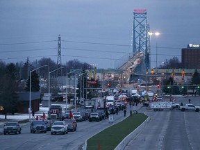 Protesters and supporters at a blockade at the foot of the Ambassador Bridge, sealing off the flow of commercial traffic over the bridge into Canada from Detroit, on February 10, 2022 in Windsor, Ont.
