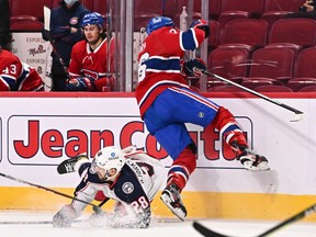 Canadiens' Jeff Petry (26) trips up Oliver Bjorkstrand (28) of the Columbus Blue Jackets during the third period at the Bell Centre on Saturday, Feb. 12, 2022, in Montreal.
