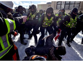 Police clash with demonstrators in Ottawa on February 18, 2022.