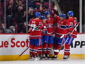 Josh Anderson #17 of the Montreal Canadiens celebrates his goal with teammates Brett Kulak #77, Cole Caufield #22, Nick Suzuki #14, and Jeff Petry #26 during the first period against the Toronto Maple Leafs at Centre Bell on Feb. 21, 2022 in Montreal.