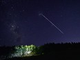 In this file photo taken on Feb. 6, 2021, this time-exposure image shows a trail of a group of SpaceX's Starlink satellites passing over Uruguay, some 185 km north of Montevideo, near Capilla del Sauce, Florida Department.