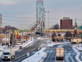Trucks drive down the road towards the Ambassador Bridge border crossing in Windsor, Ontario, Canada, on February 14, 2022.